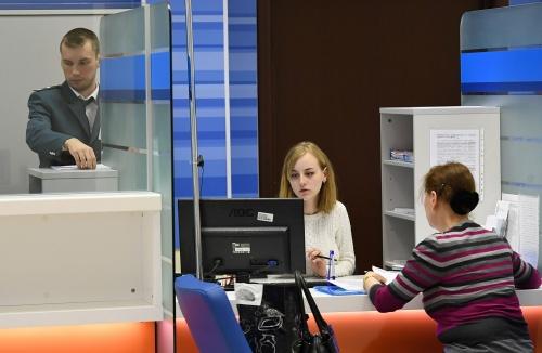 Сотрудники помогают посетительнице со сдачей налоговой отчетности в день открытых дверей в операционном зале инспекции Федеральной налоговой службы РФ в Москве2
