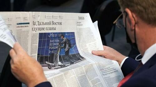 Участник Восточного экономического форума во Владивостоке читает газету перед началом сессии5